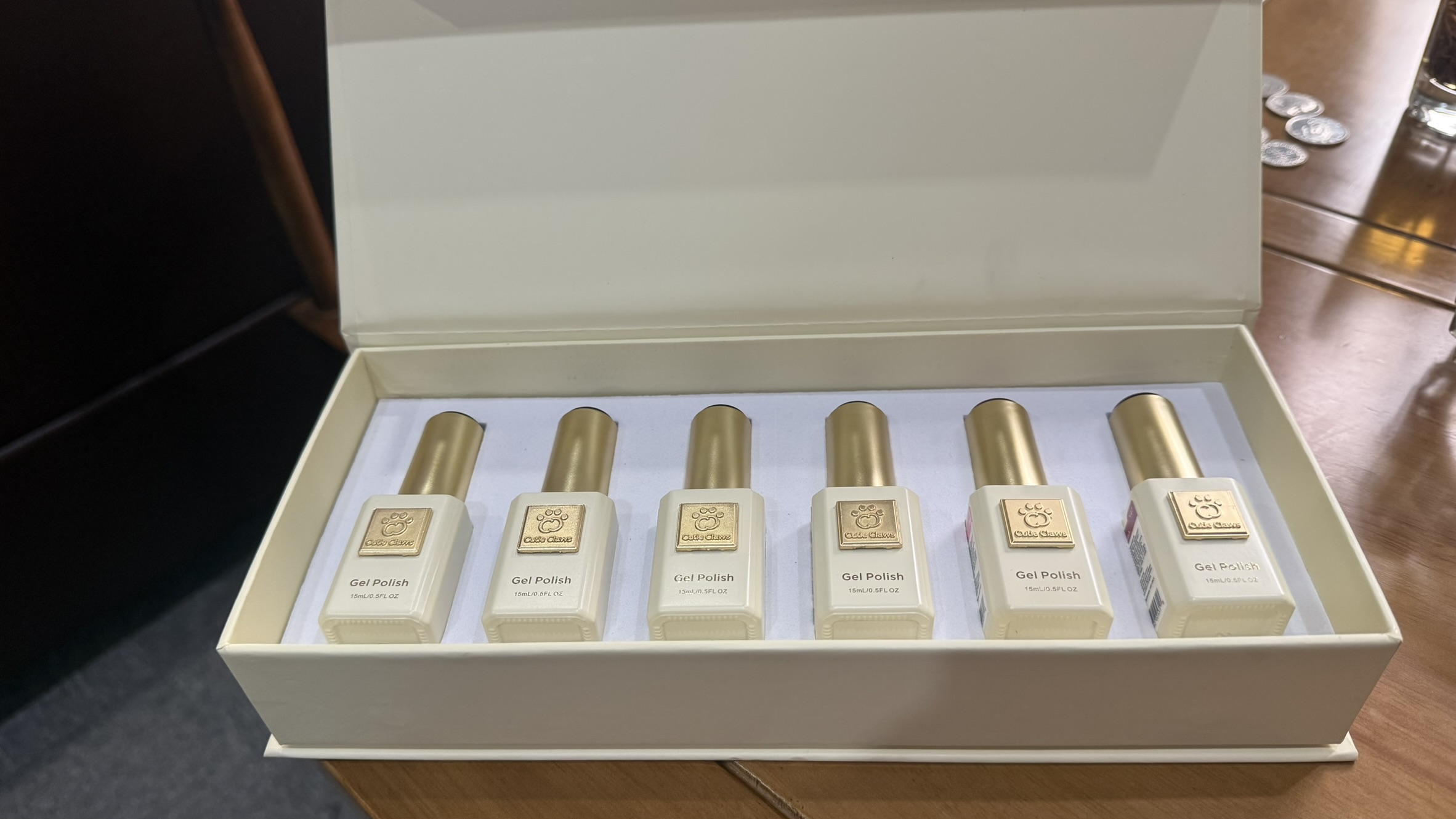 Cutie Claws ivory presentation box with six ivory gel polish bottles and gold caps